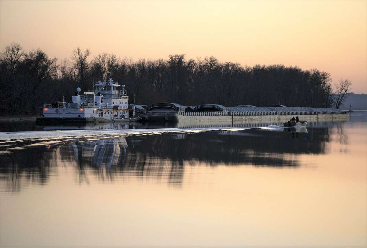 Barges move down the Illinois River on Dec. 8. In addition to cargo, the river is carrying phosphorus and nitrogen to the Gulf of Mexico, contributing to a dead zone where fish swim away or die.