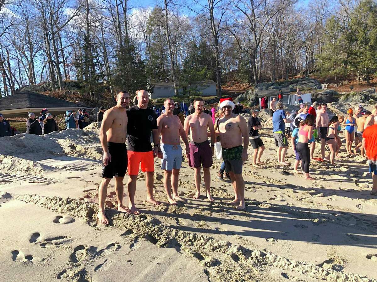 Members of the Ridgefield Police Department posed for a photo before plunging into the chilly waters at Martin Park Beach.
