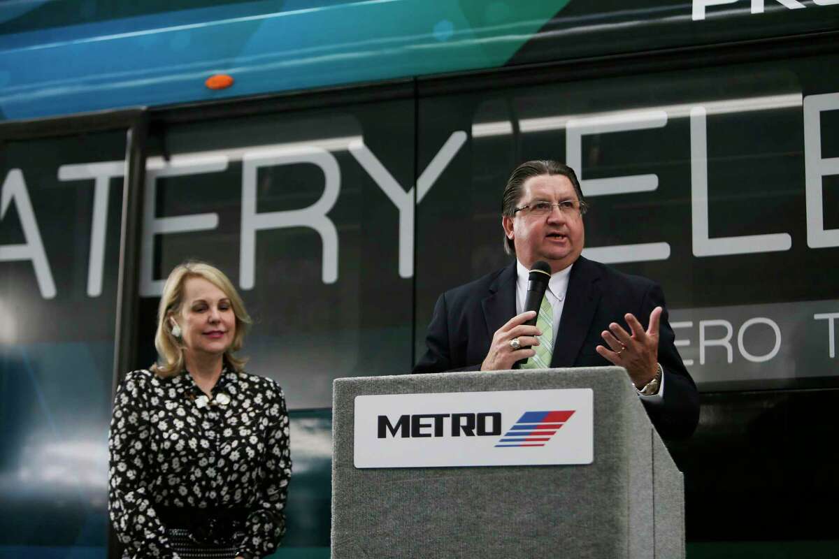 Metro board chair Carrin Patman, left, listens as Metro CEO Thomas Lambert speaks during the Nov. 29, 2016, unveiling of an electric bus that Metro tested for three months.