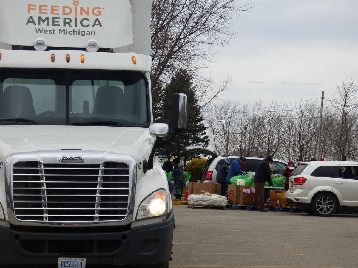 Volunteers distribute food boxes delivered by Feeding American West Michigan on Dec. 20. 