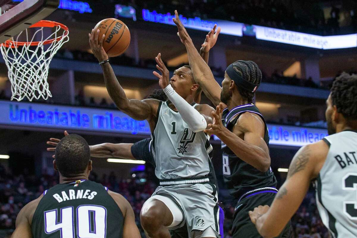 San Antonio Spurs guard Lonnie Walker IV (1) lays the ball up against the Sacramento Kings during the first quarter of an NBA basketball game in Sacramento, Calif., Sunday, Dec. 19, 2021. 