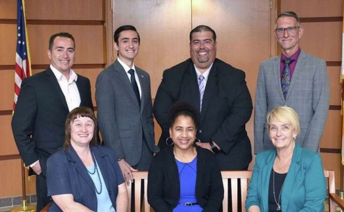 San Leandro Unified school board President Christian Rodriguez, standing at left, died Monday after he was struck by a vehicle on Friday, officials said.