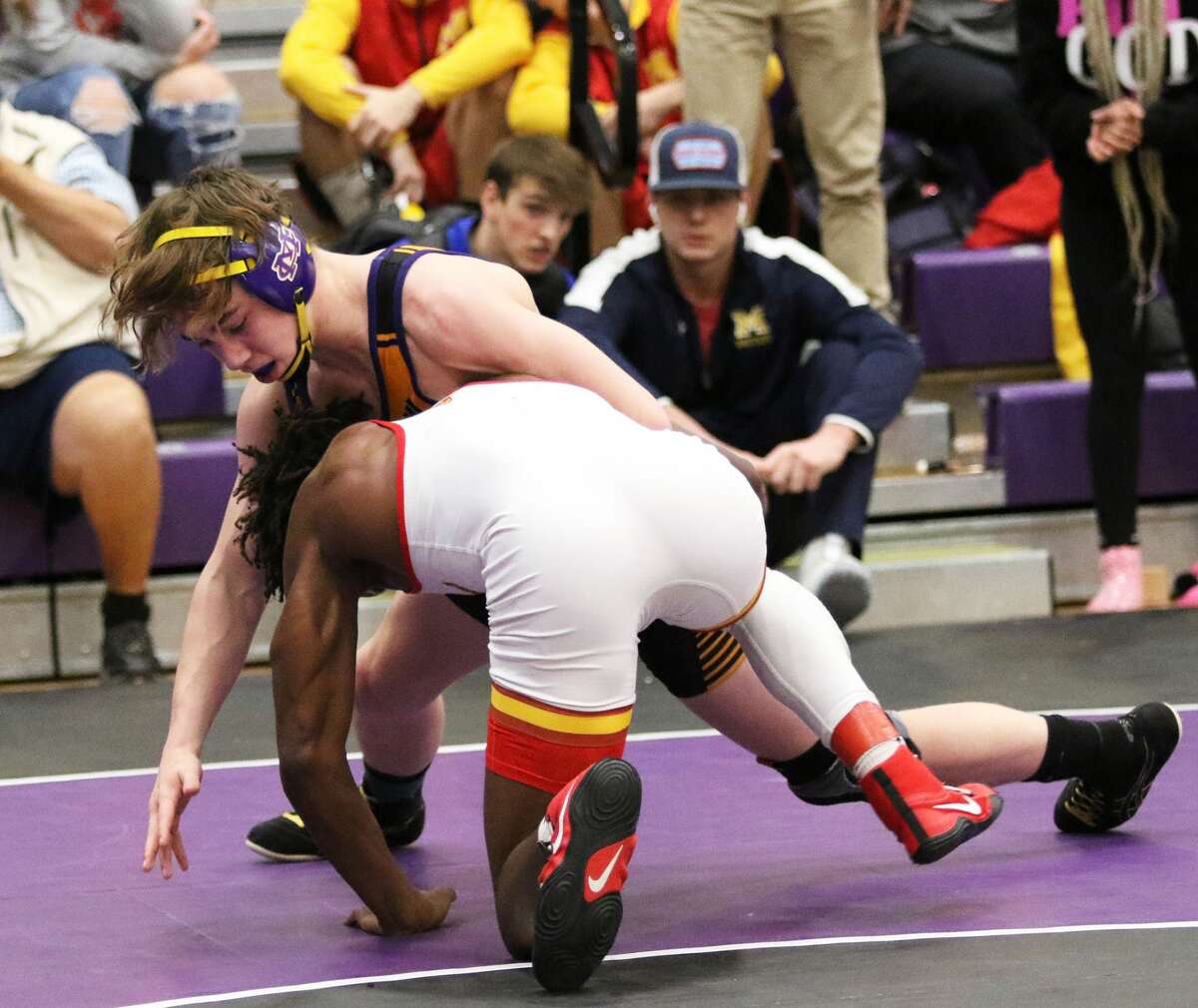 Murphysboro's Arojae Hart takes a shot on CM's Bryce Griffin in their 138-pound title bout at Saturday's Mascoutah Tourney.