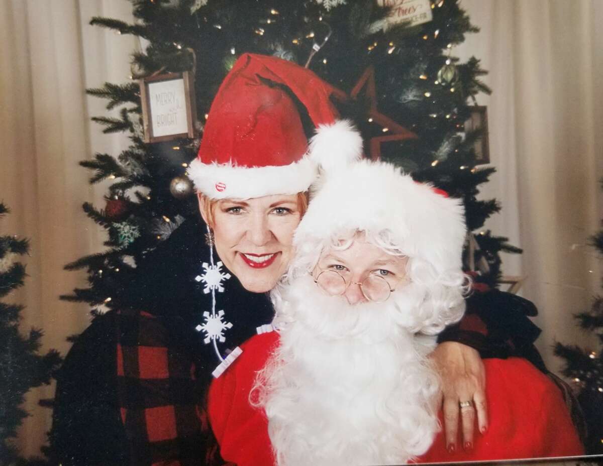 Carolyn Koester in a picture with Santa in her office at Berkshire Hathaway HomeServices Select Properties. 