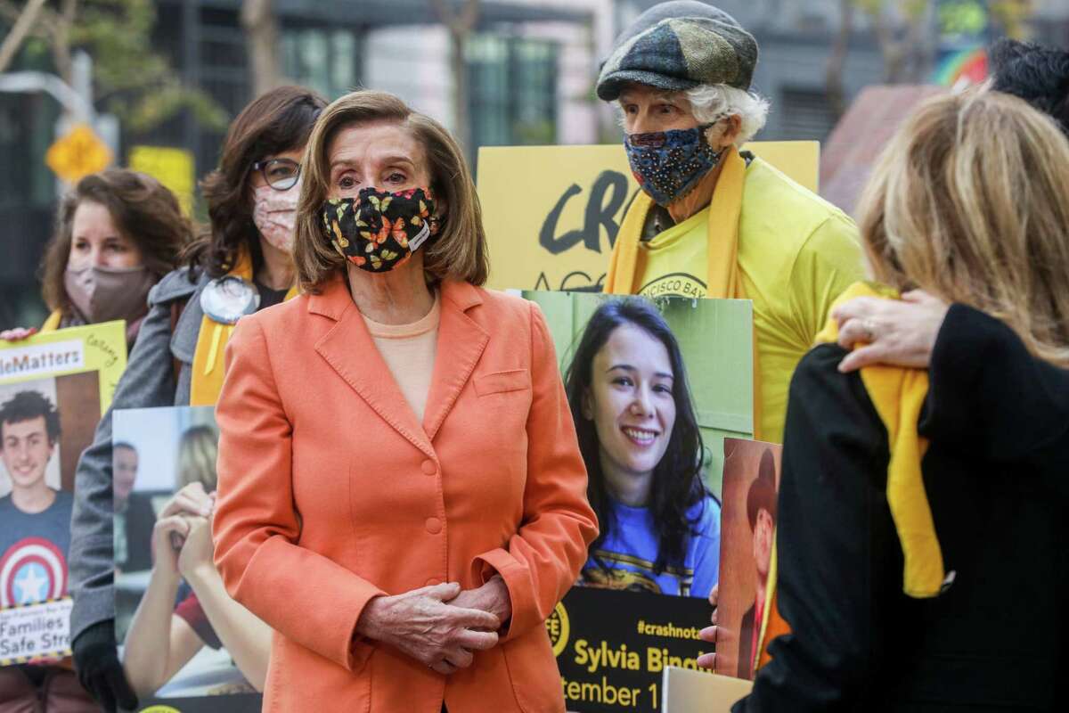 House Speaker Nancy Pelosi, standing with relatives of pedestrians killed in car crashes, touts the funds coming to the Bay Area from Washington for street safety improvement measures.