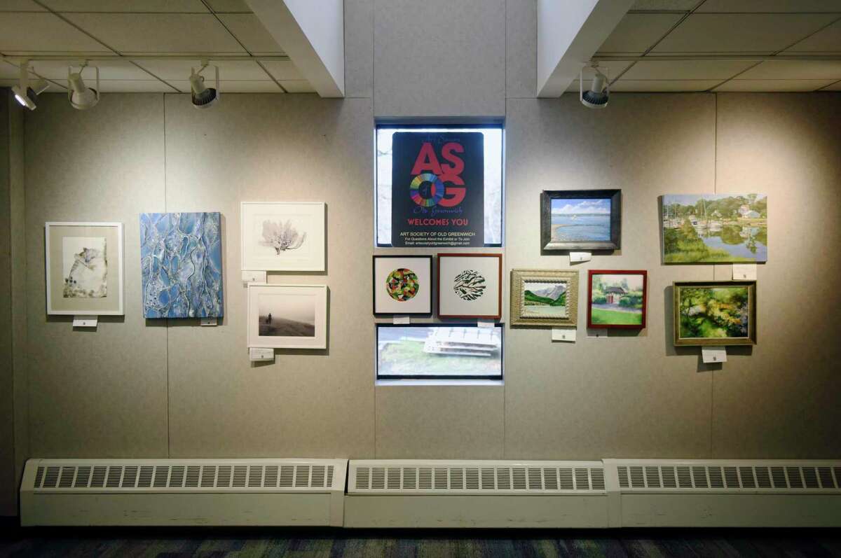 Art is displayed at the Art Society of Old Greenwich Members Holiday Exhibit at the YWCA's Gertrude White Gallery in Greenwich, Conn. Tuesday, Dec. 14, 2021. Work from local artists in a variety of mediums including oil, acrylic, watercolor, photography, mixed media, and drawing are displayed in the gallery until Dec. 29.
