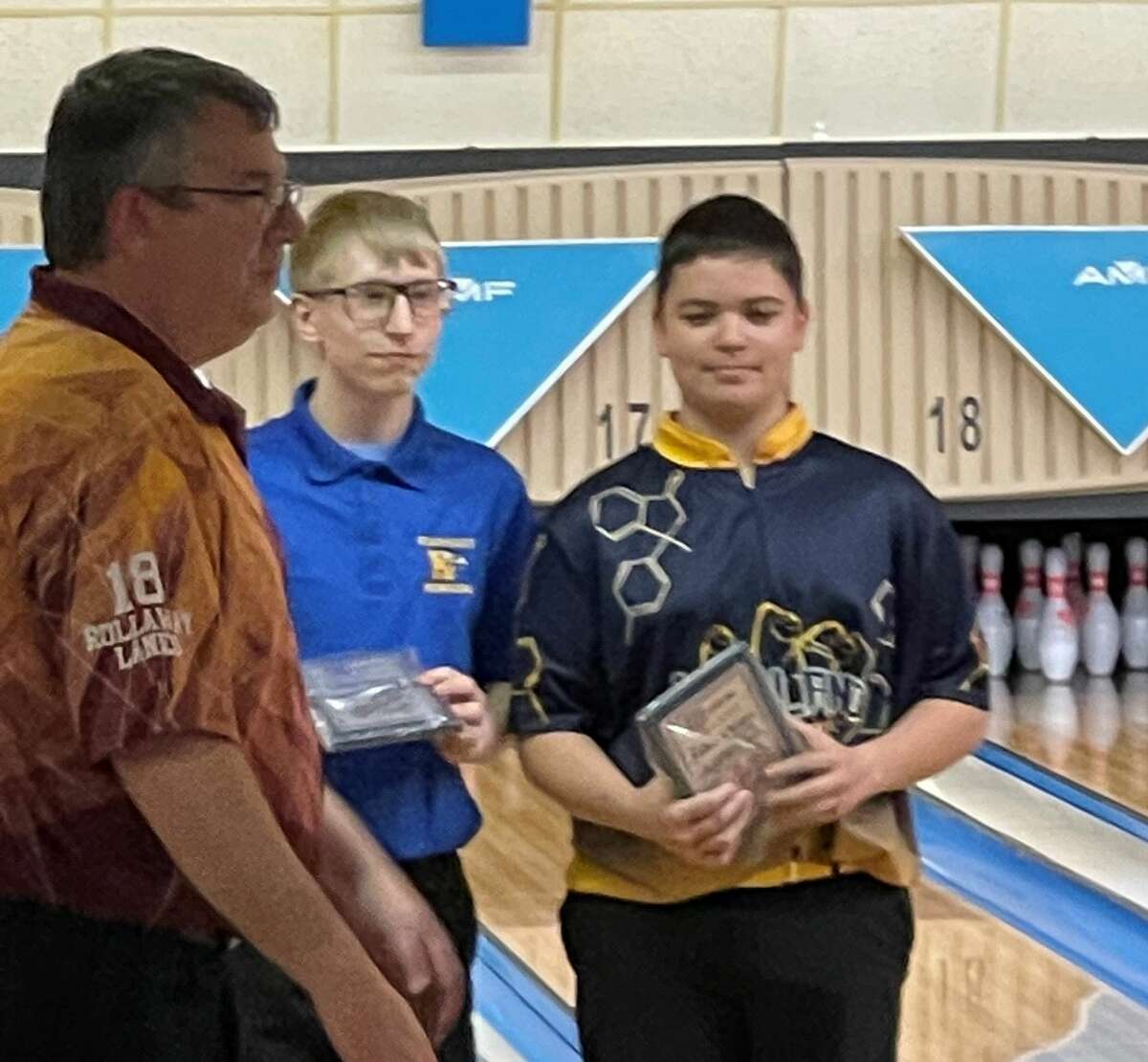 Midland High's Evan Daly (right) receives his all-tournament plaque after his performance at a tourney held at Bay City's Monitor Lanes earlier this season.