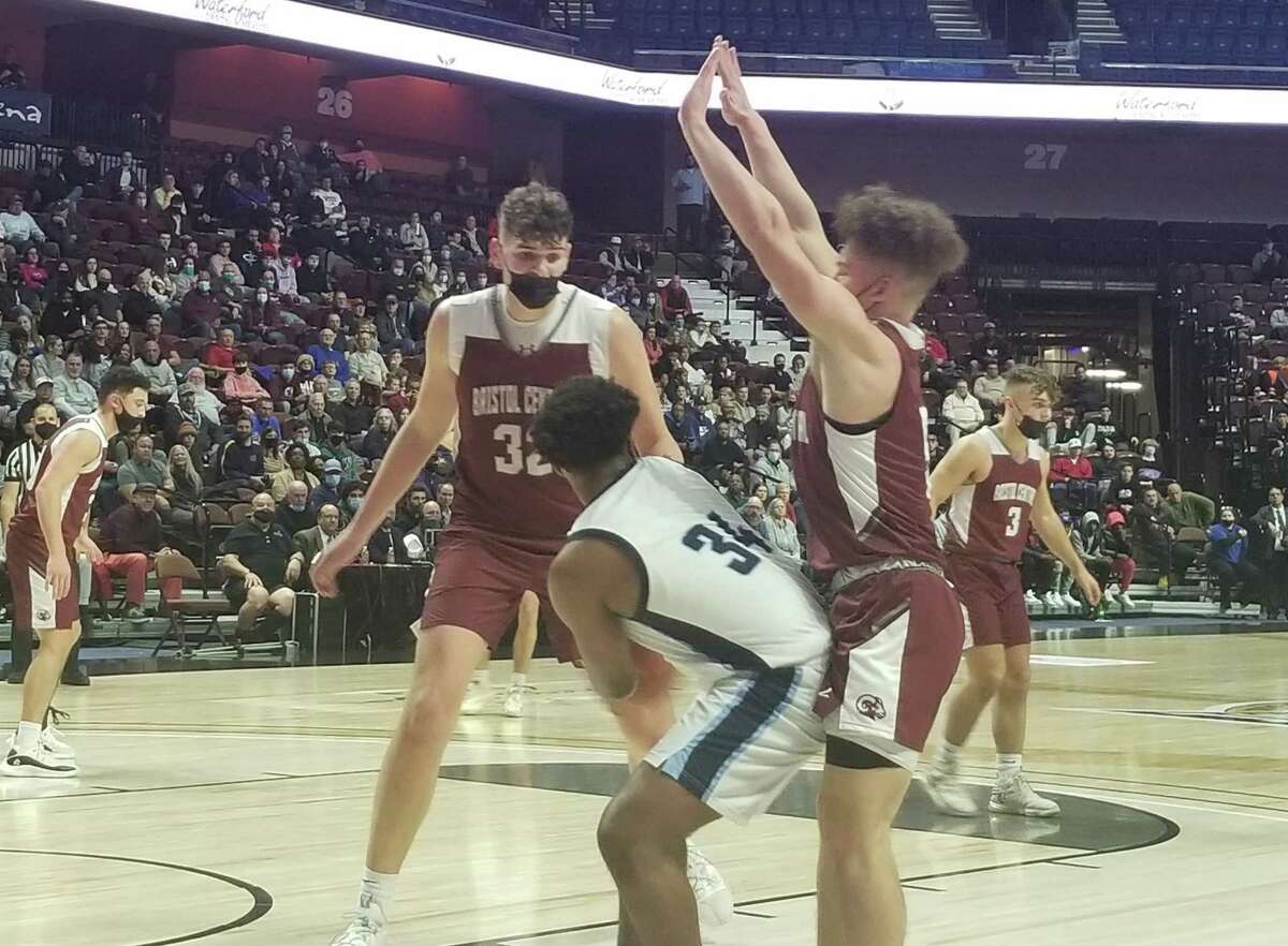Donovan Clingan (left) and Damion Glasper double-team East Catholic's Leondre Sanchez during Bristol Central's 74-59 victory at the Mohegan Sun Arena on Dec. 20, 2021.