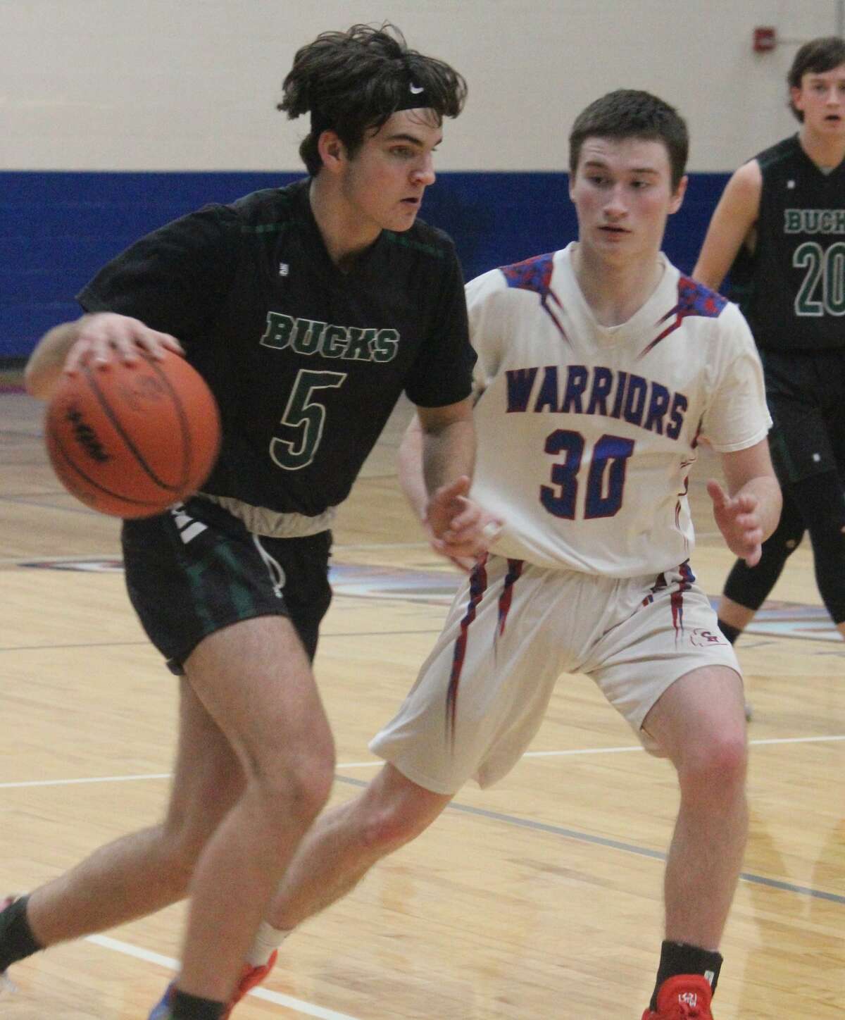 Pine River's Tanner Prosch (5) drives on Chippewa Hills' Scott Miller (30) in Monday night boys basketball action.