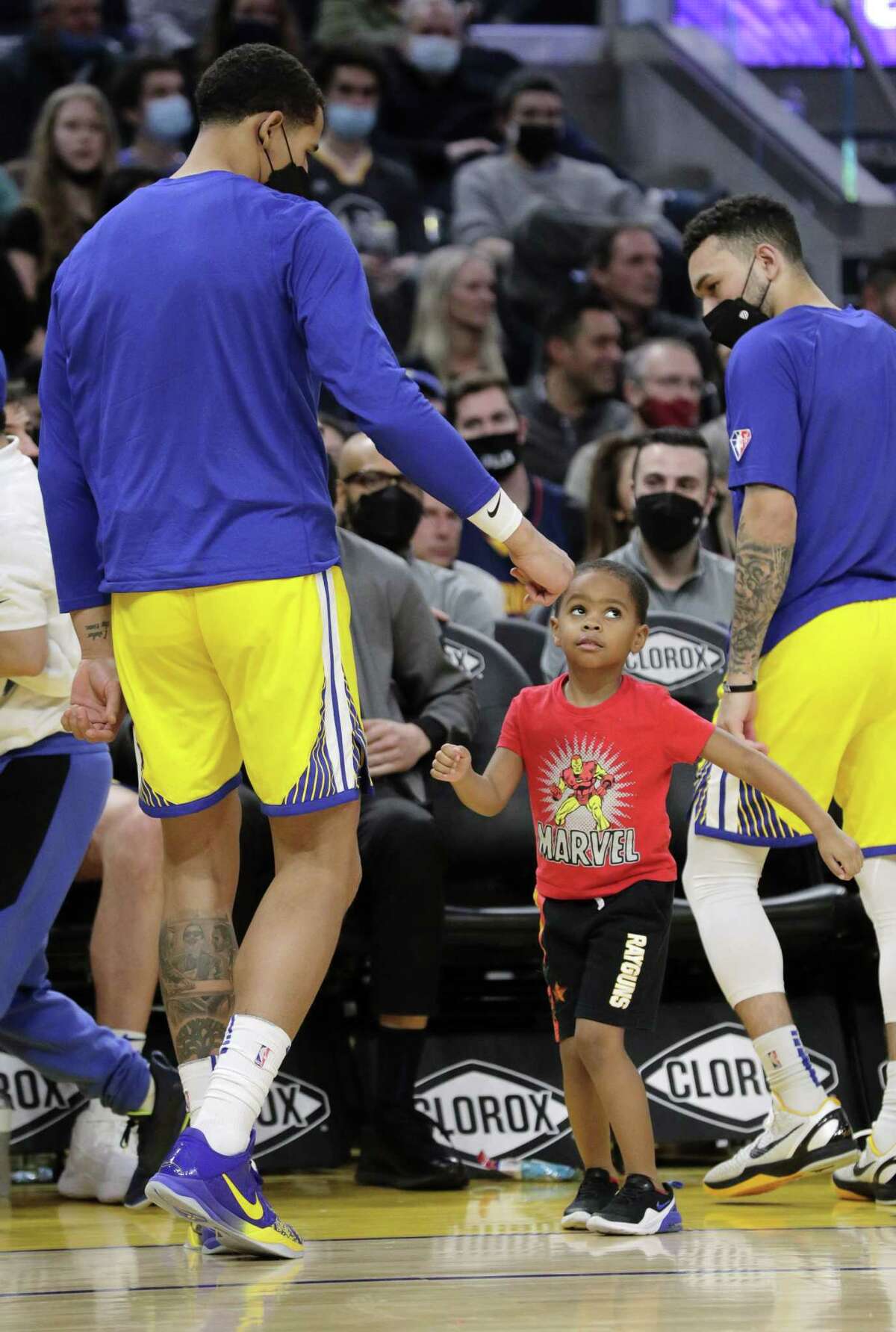 Draymond Jamal Green, 4, dances with Juan Toscano-Anderson during a pause in Monday’s game at Chase Center.