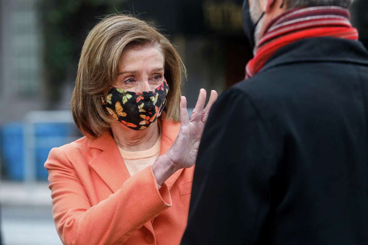 House Speaker Nancy Pelosi waves at a pedestrian during a press conference in San Francisco, Calif. on Dec. 20, 2021. The new congressional district lines approved by the Citizens Redistricting Commission largely spare the Bay Area from major changes.