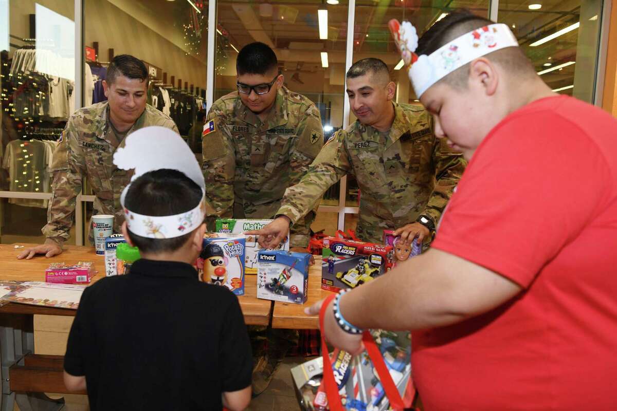 Members of the National Guard and the Texas State Guard gathered to give military family elementary children the gift of toys and candy on Monday during the Operation: Toy Drop at the Outlet Shoppes.