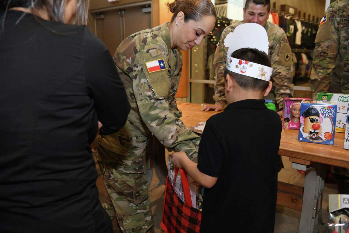 Members of the National Guard and the Texas State Guard gathered to give military family elementary children the gift of toys and candy on Monday during the Operation: Toy Drop at the Outlet Shoppes at Laredo.