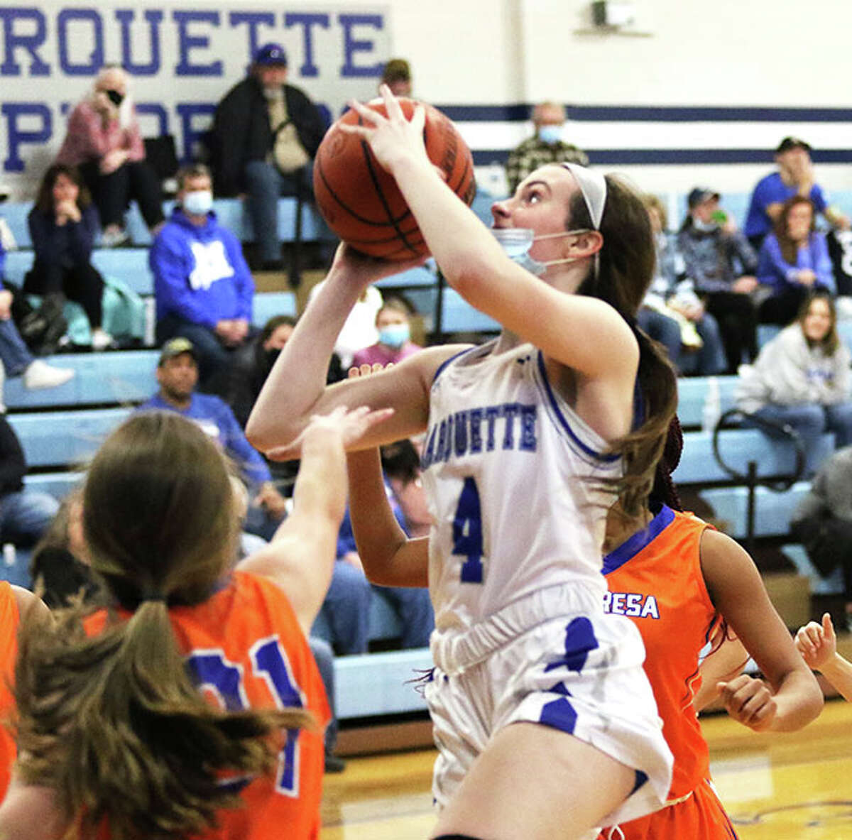 Marquette's Abby Williams (4) puts up a shot in the lane against Decatur St. Teresa earlier this season in Alton. On Monday night back at home, Williams had nine points and seven rebounds in an Explorers' win over Collinsville.