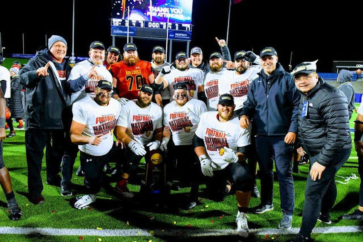 Kurt Faust (far left) poses with Ferris State's offensive line following the Bulldogs' win over Valdosta State in the NCAA Division II national championship game on Saturday, Dec. 18, 2021.