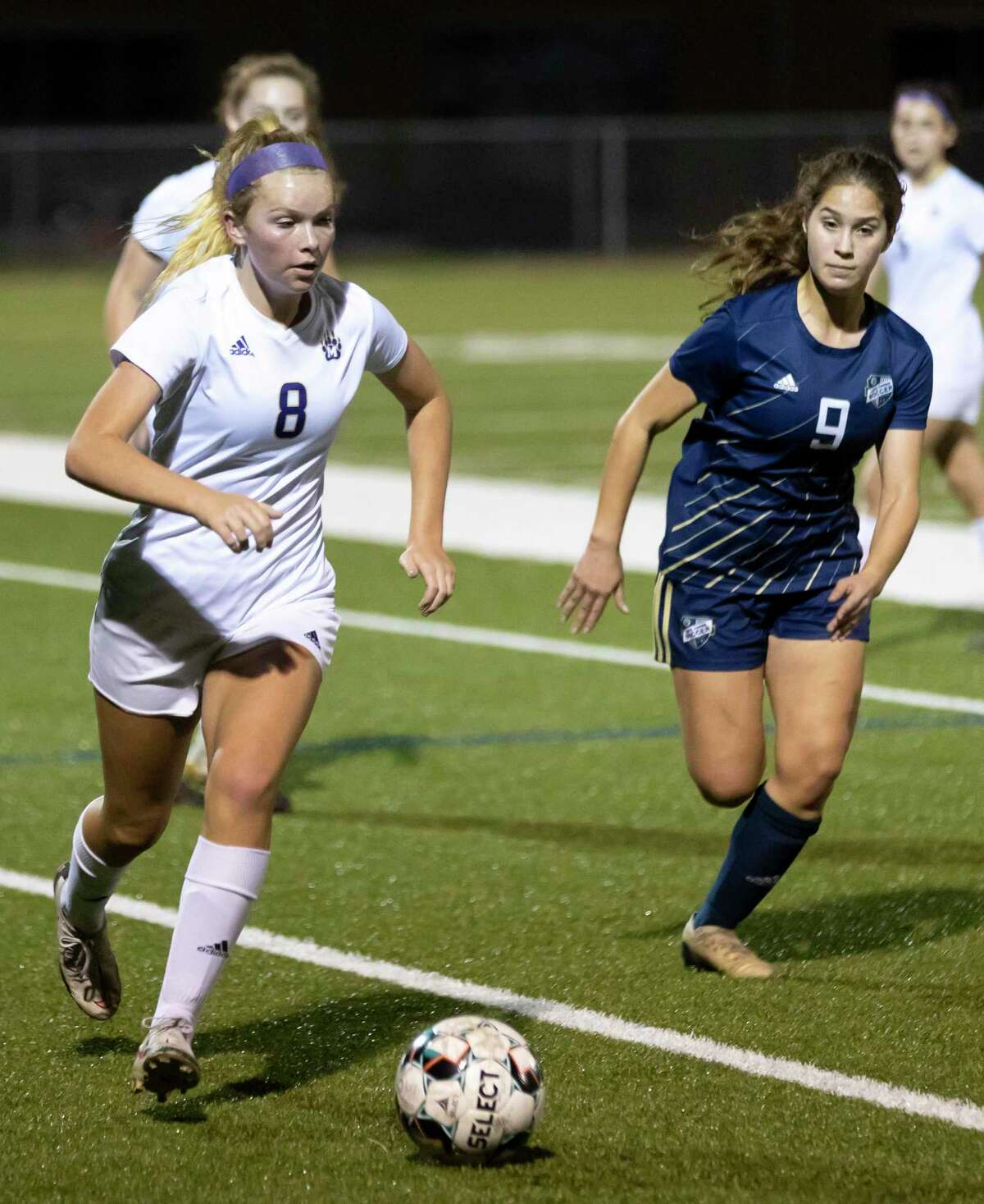 Montgomery midfielder Mable Pruter (8) drives the ball after intercepting a pass to Lake Creek Isabella Ibanez (9) during the first half of a District 20-5A girls soccer game at Lake Creek High School, Friday, Feb. 26, 2021, in Montgomery.
