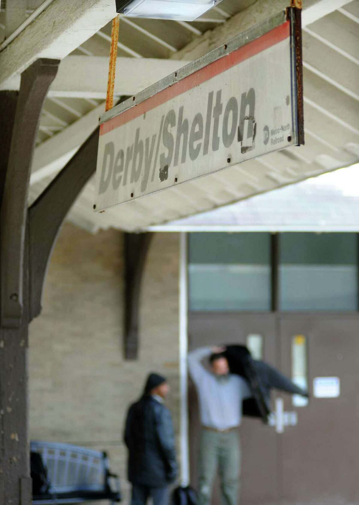 Commuters wait for a Metro-North train to pull into the Derby/Shelton station in Derby.