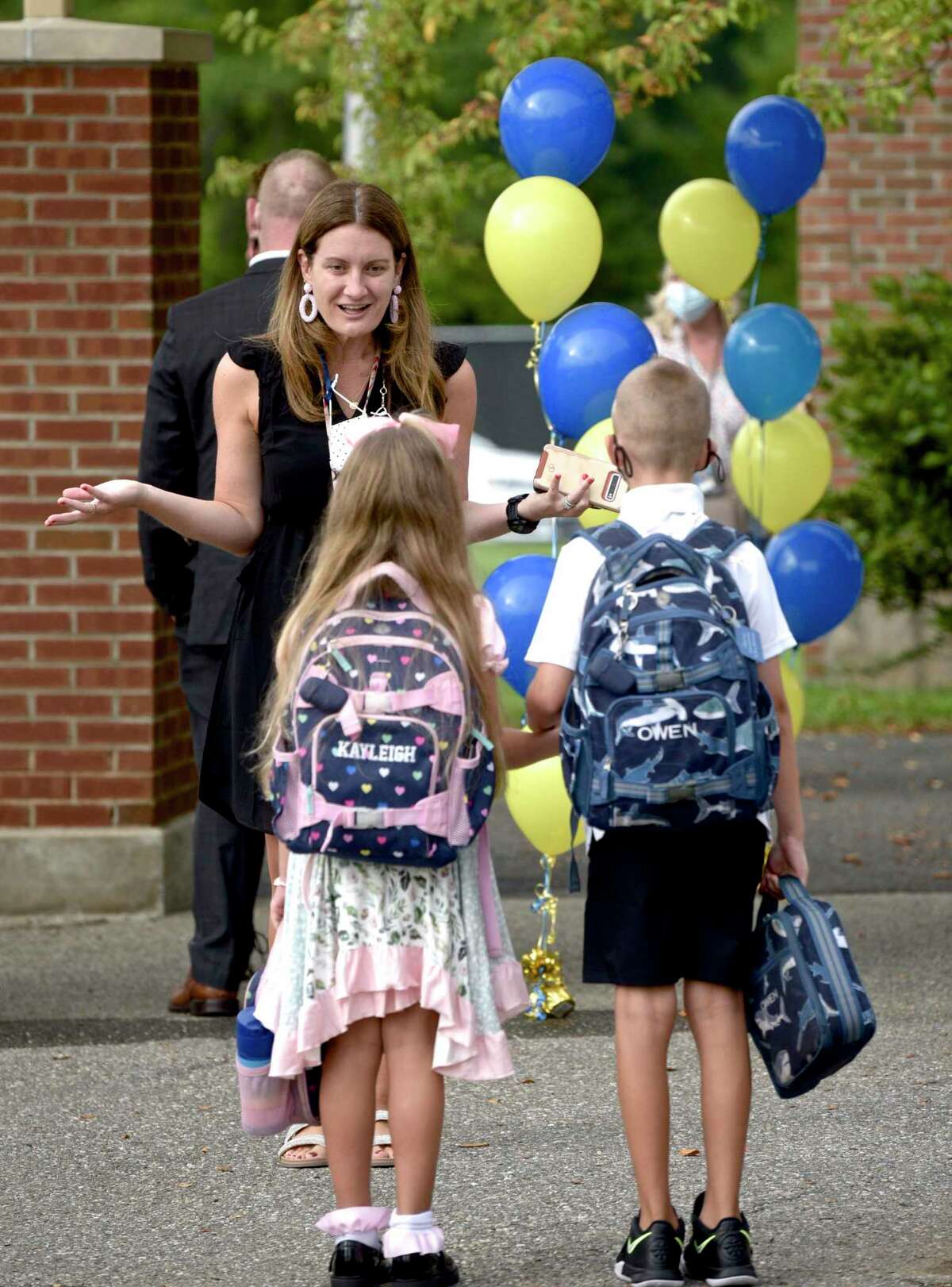 Principal Melissa Labrosciano welcomes student back on the first day of new school year at Huckleberry Hill School, Brookfield, Conn. Tuesday, August 31, 2021.