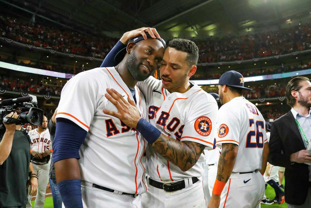 Houston Astros designated hitter Yordan Alvarez (44) ad Houston Astros shortstop Carlos Correa (1) celebrate as they win Game 6 of the American League Championship Series and advance to the World Series on Friday, Oct. 22, 2021 at Minute Maid Park in Houston.