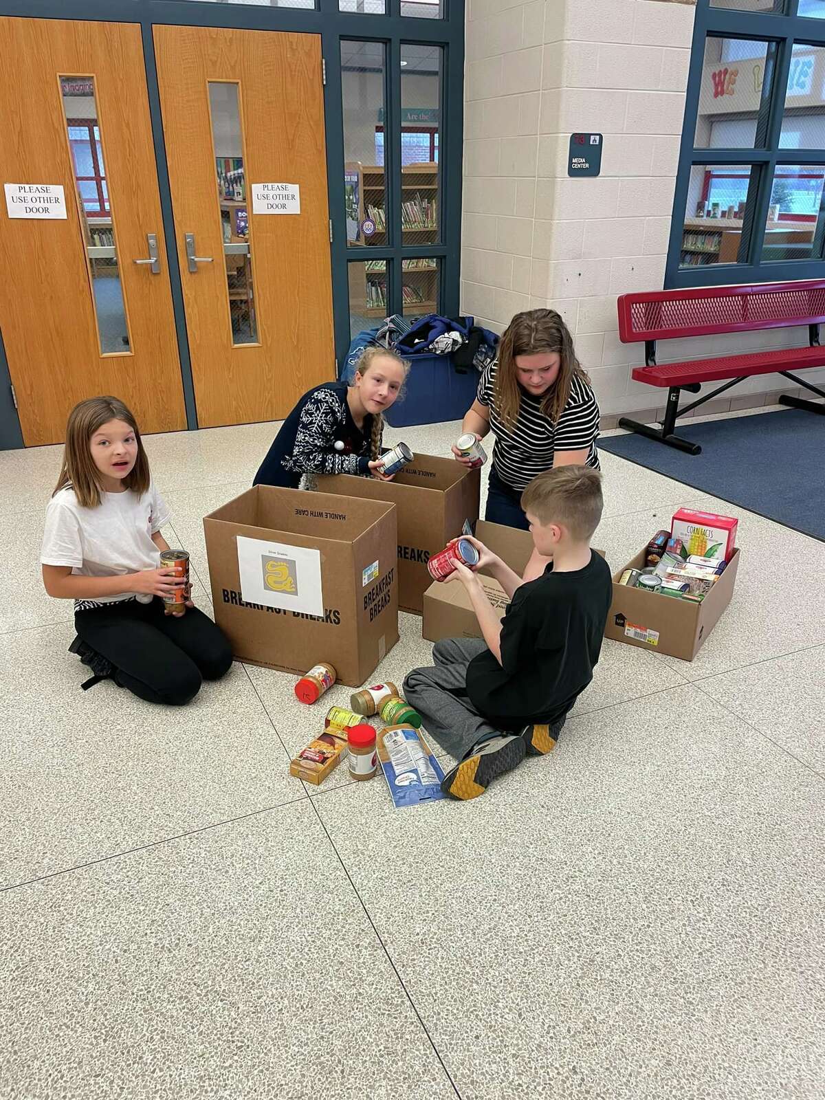 Sebewaing elementary students donate and box food for charity.