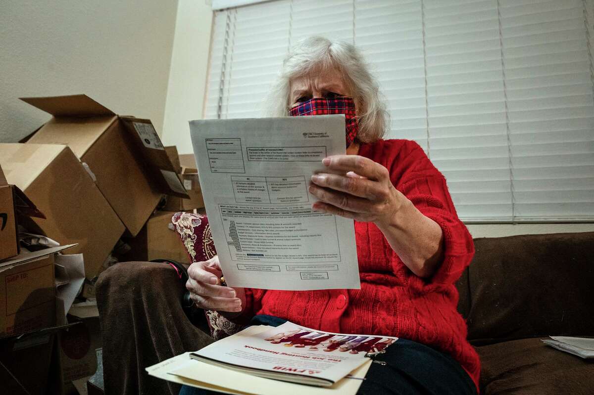Nance Parry spends hours each day at home searching job listings on the internet and printed out lists of local job postings at her home in Duarte on Dec. 6, 2021. Photo by Raquel Natalicchio for CalMatters