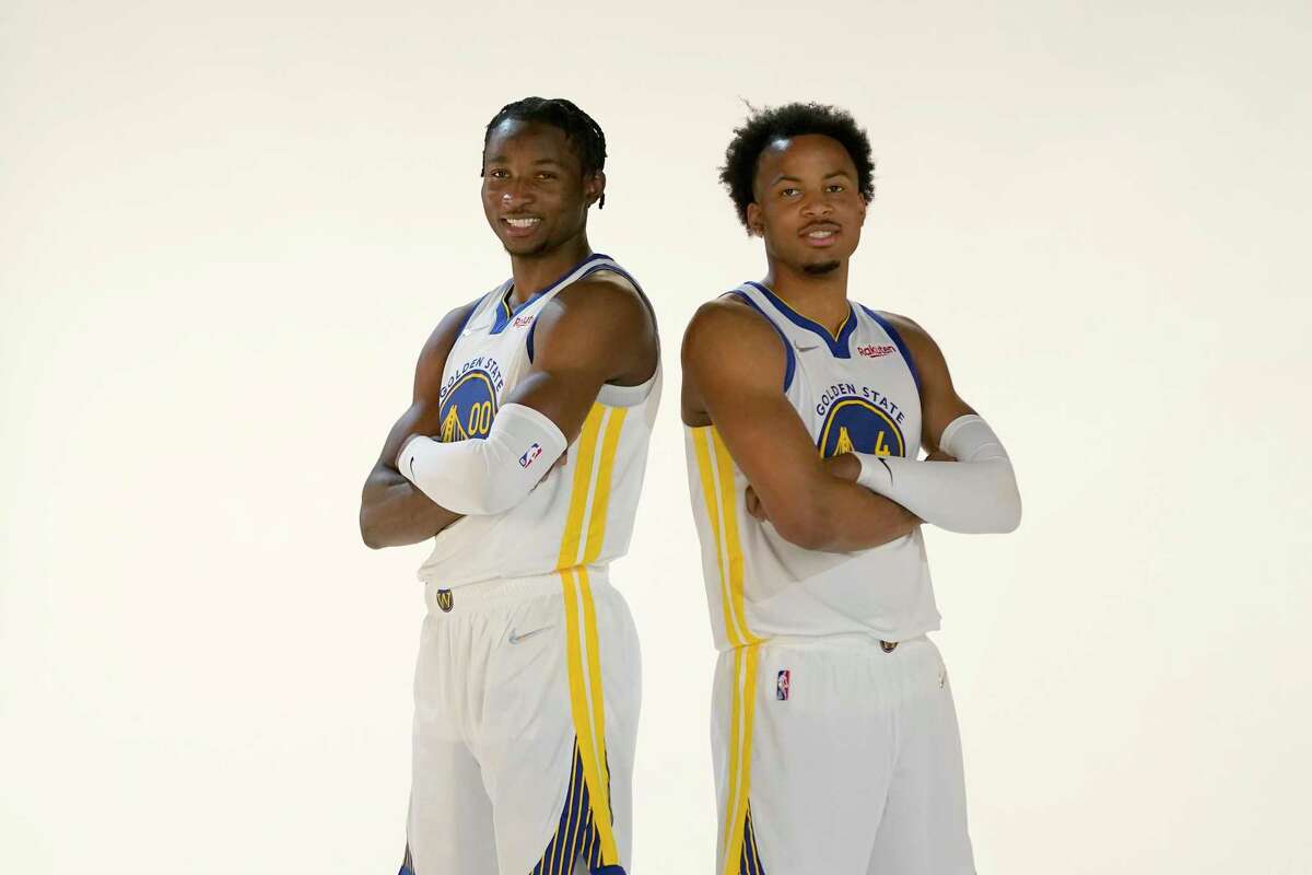 Golden State Warriors' Jonathan Kuminga, left, poses for photos with Moses Moody during the NBA basketball team's media day in San Francisco, Monday, Sept. 27, 2021. (AP Photo/Jeff Chiu)