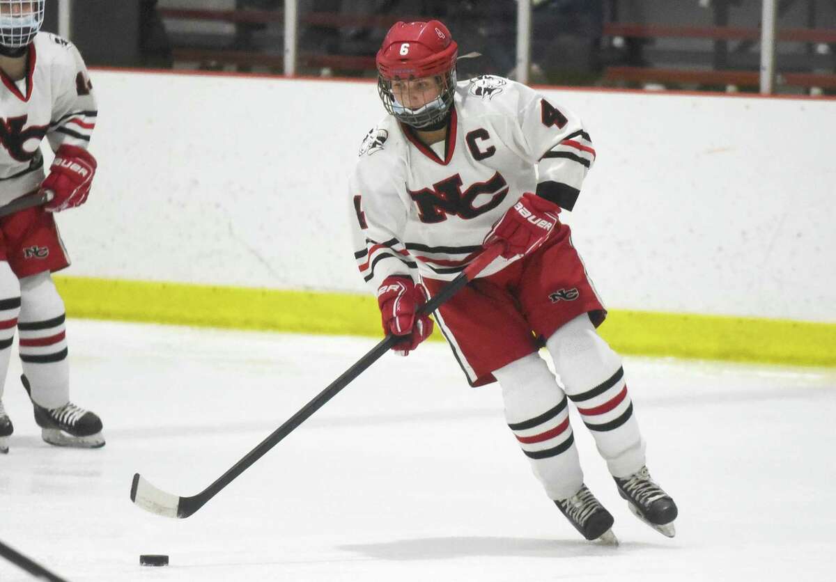 New Canaan's Kaleigh Harden (4) skates with the puck during a girls ice hockey game against the Stamford/Westhill/Staples co-op at the Darien Ice House on Saturday, Dec. 28, 2021.