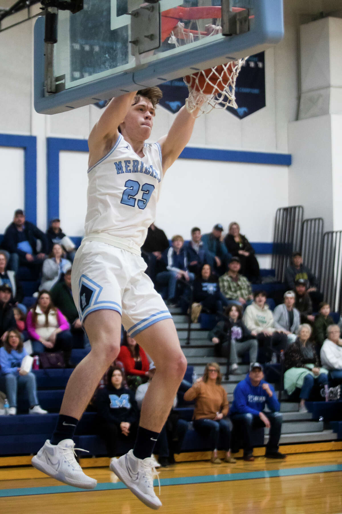 Meridian's Sawyer Moloy dunks the ball during the Mustangs' game against Bullock Creek Tuesday, Dec. 21, 2021 at Meridian Early College High School.