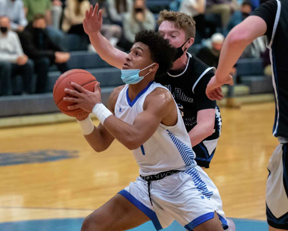 LaSalle Institute senior JJ Thompson drives the lane in front of Ichabod Crane defender Alex Schmidt during a Colonial Council matchup at LaSalle Institute in Troy, NY, on Tuesday, Dec. 21, 2021. (Jim Franco/Special to the Times Union)