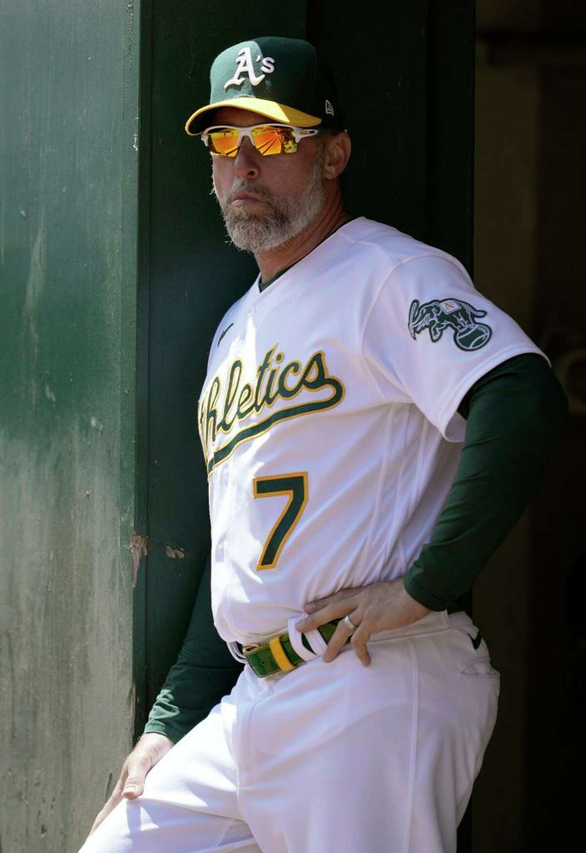 OAKLAND, CALIFORNIA - AUGUST 04: Third base coach Mark Kotsay #7 of the Oakland Athletics looks on from the dugout against the San Diego Padres in the top of the first inning at RingCentral Coliseum on August 04, 2021 in Oakland, California.