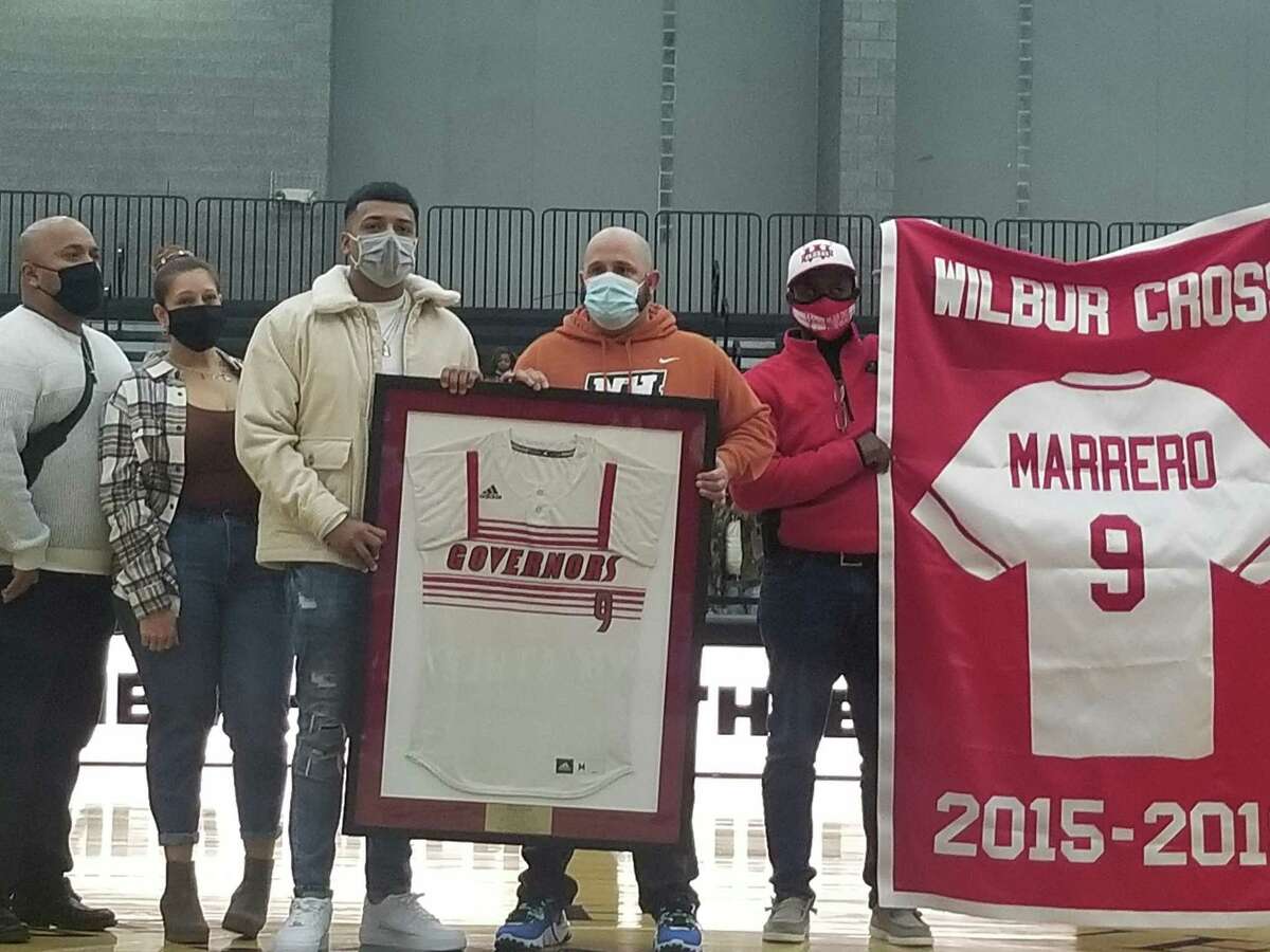 Former Wilbur Cross baseball standout and current member of the St. Louis Cardinals' organization Andrew Marrero (left) had his No. 9 retired in a ceremony at the Floyd Little Athletic Center in New Haven Dec. 21, 2021.