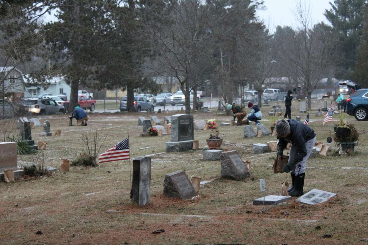 Volunteers helped place more than 1,000 luminaries around the Maple Grove Township Cemetery in Kaleva on Tuesday, the winter solstice.
