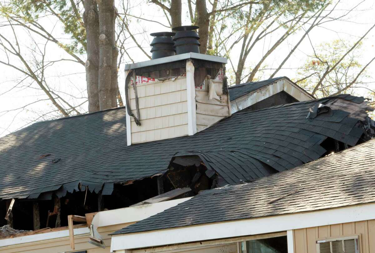 A chimney is seen on the roof where a recent fire happened at 31 Coachman Square at Twin Lakes apartment complex on Wednesday, Nov. 10, 2021 in Clifton Park, N.Y.