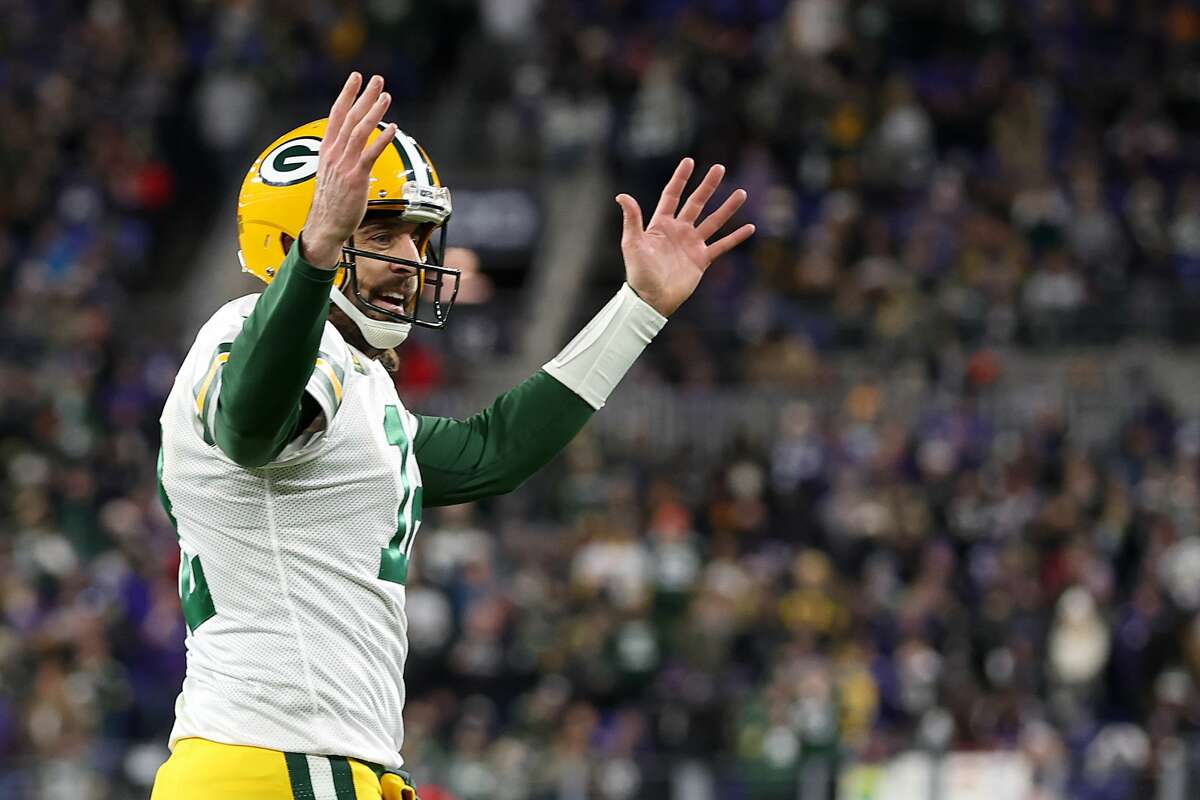 BALTIMORE, MARYLAND - DECEMBER 19: Quarterback Aaron Rodgers #12 of the Green Bay Packers celebrates a touchdown pass against the Baltimore Ravens in the first half at M&T Bank Stadium on December 19, 2021 in Baltimore, Maryland. (Photo by Rob Carr/Getty Images)