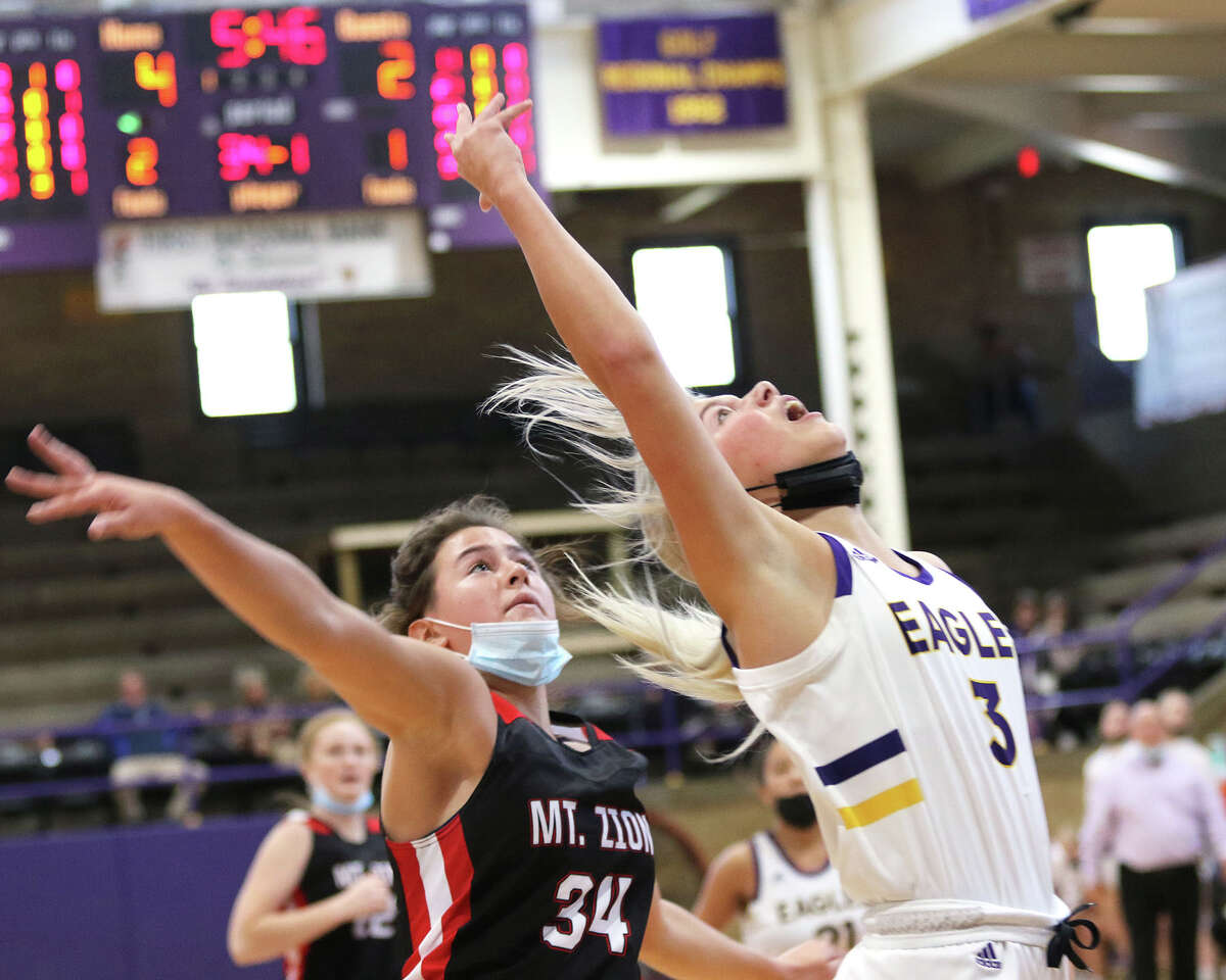 CM's Kelbie Zupan (right) watches her layup score after getting past Mount Zion's Denver Anderson on a break during a Taylorville Tourney game in November. Zupan scored 15 points to lead the Eagles past Highland on Tuesday night in Bethalto.