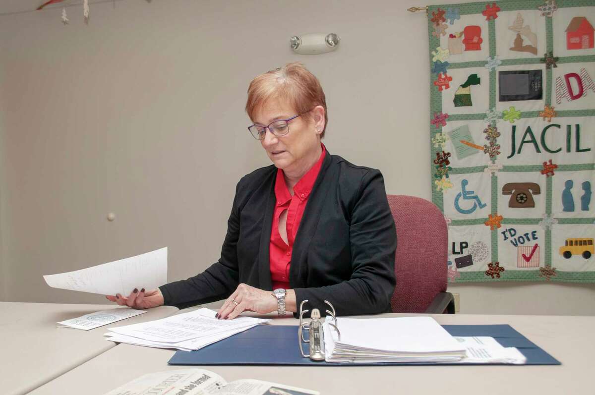 Jacksonville Area Center for Independent Living Executive Director Peggy Davidsmeyer sorts through past minutes from the Jacksonville Commission on Disabilities and Human Relations. Davidsmeyer recently was appointed chair of the commission.