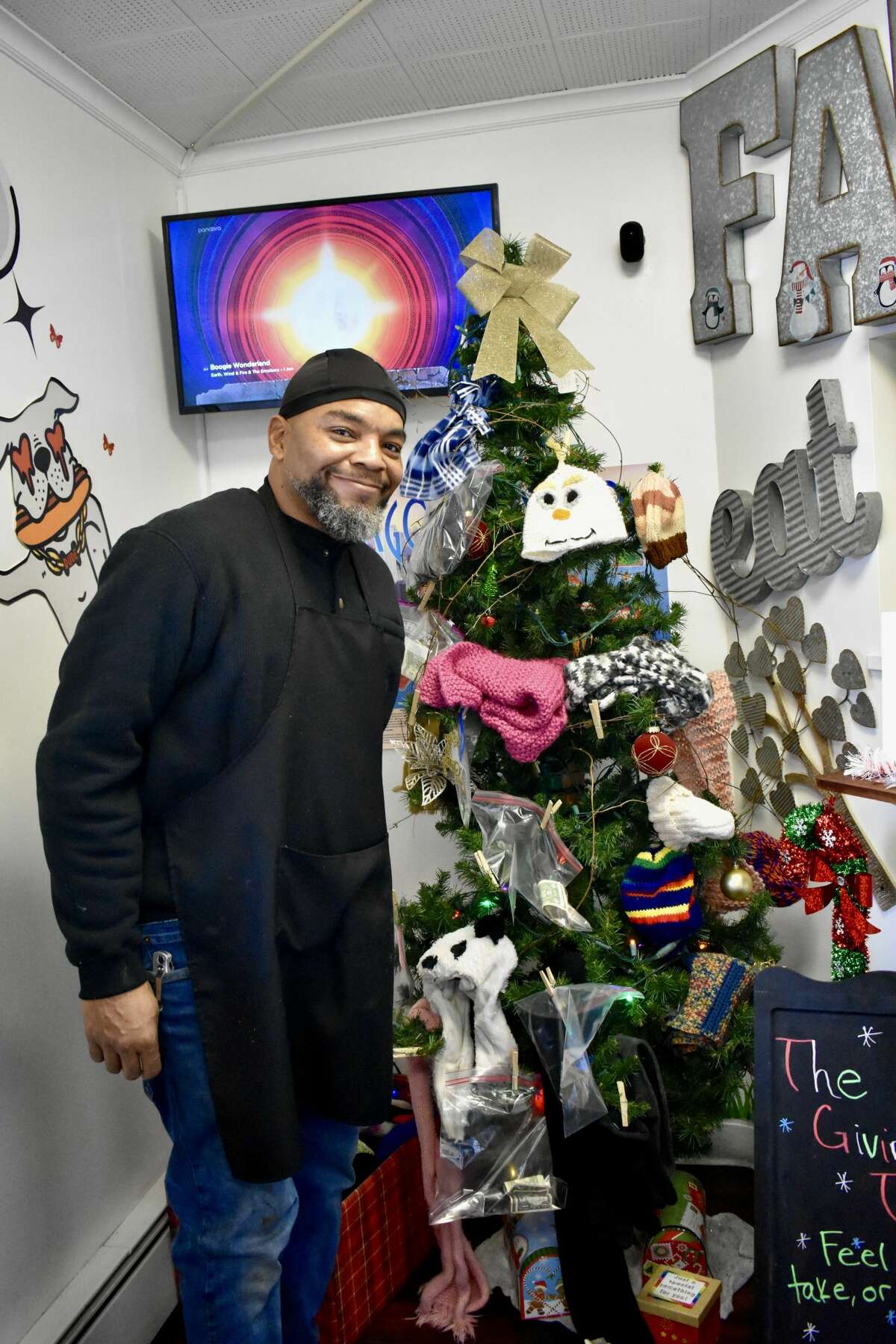 Bernard Agee, owner of Fatty C's Dog House, recently put up a 'giving tree' to help people in need during the holiday season filled up with hand-knitted, colorful hats, gloves and scarves for the taking. 