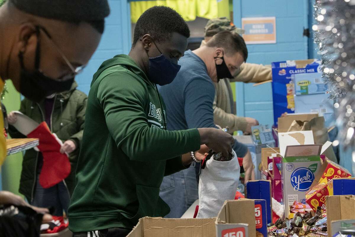 Volunteers stuff candy into Christmas stockings for 500 foster kids at Victory Church on Tuesday, Dec. 21, 2021 in Colonie, N.Y (Lori Van Buren/Times Union)