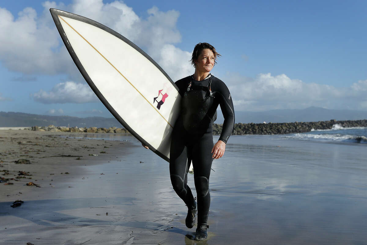 Bianca Valenti walks on the beach after surfing waves at Mavericks in Half Moon Bay, Calif.