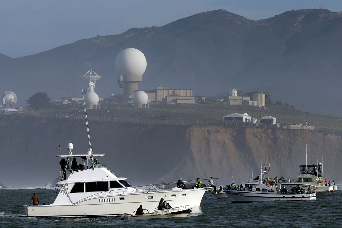 Boats congregate near the area of the Mavericks surfing contest Friday, Feb. 12, 2016, in Half Moon Bay, Calif.