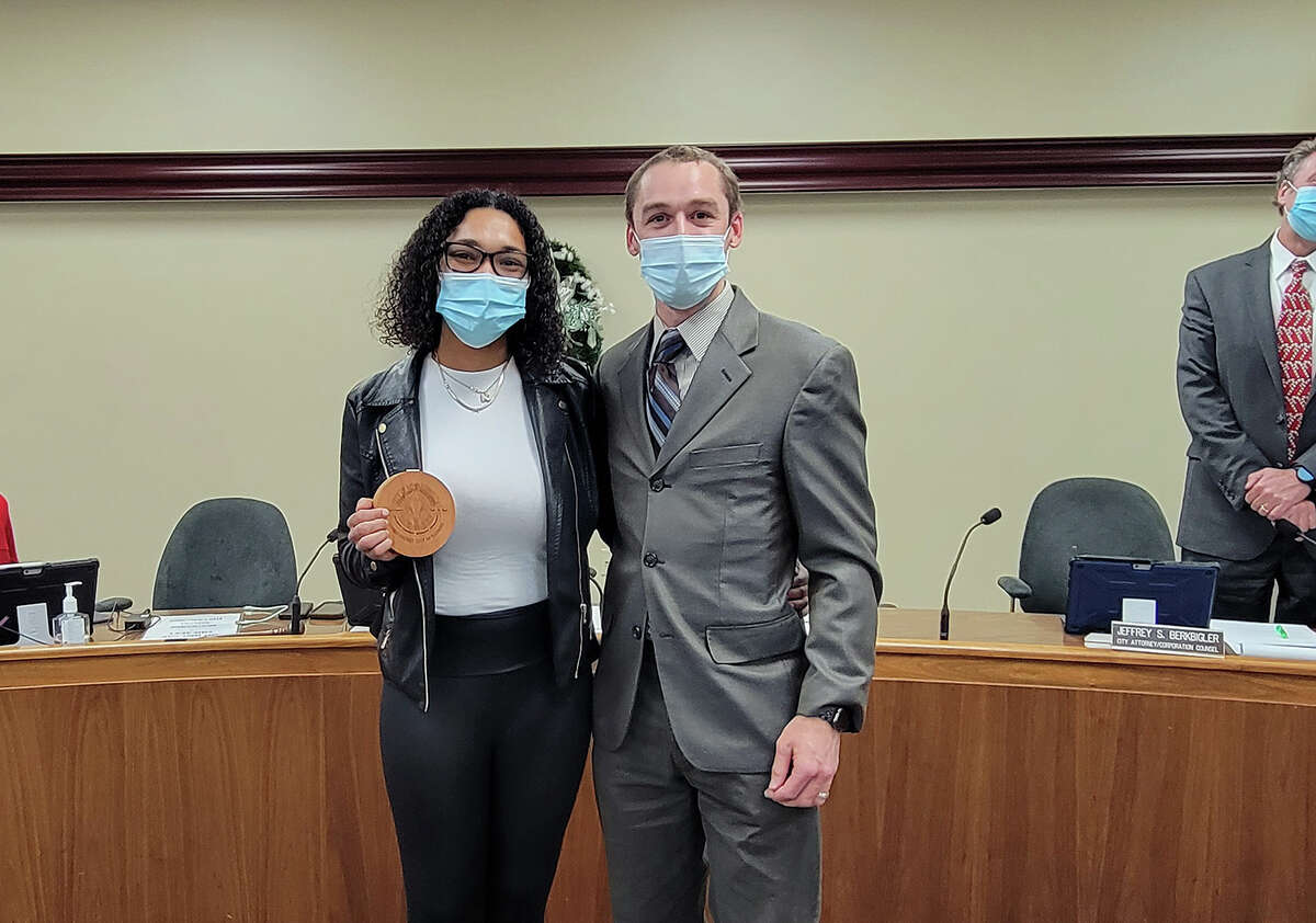 Caregiver Keyona Harris, left, poses with the man she helped save earlier this year, Gregg Signorotti, at city council Tuesday. Harris earned the city's Excellence in Edwardsville honor for her actions. 