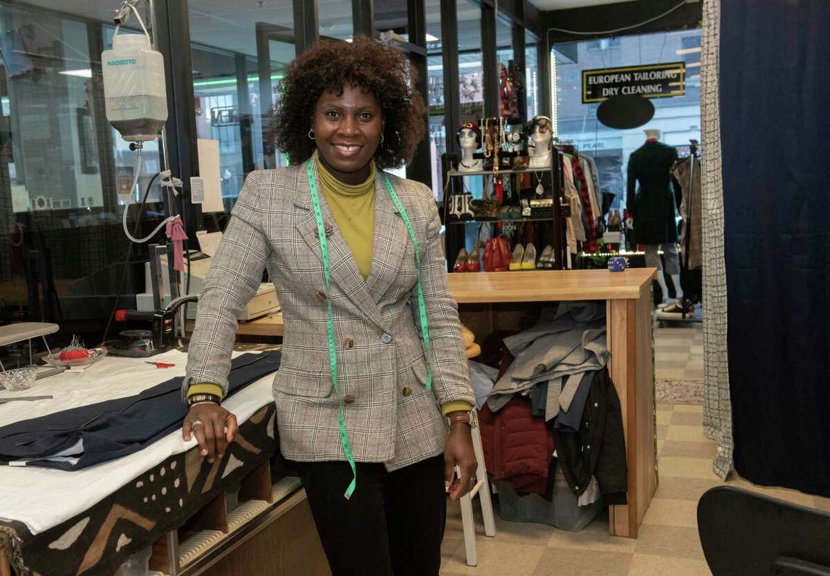 Mo Rabiu stands in her shop European Tailoring and Alterations on Wednesday, Dec. 22, 2021 in Albany, N.Y.