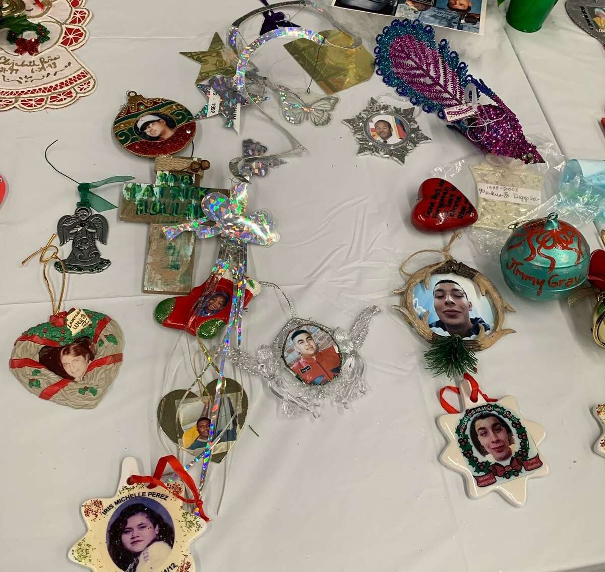 Christmas tree ornaments with portraits of Houston homicide victims are displayed on a table in the lobby of the Crime Stoppers of Houston headquarters. Every year, the nonprofit victims’ advocacy organization invites surviving family members to hang the ornaments on a Christmas tree to be displayed through the holiday season.