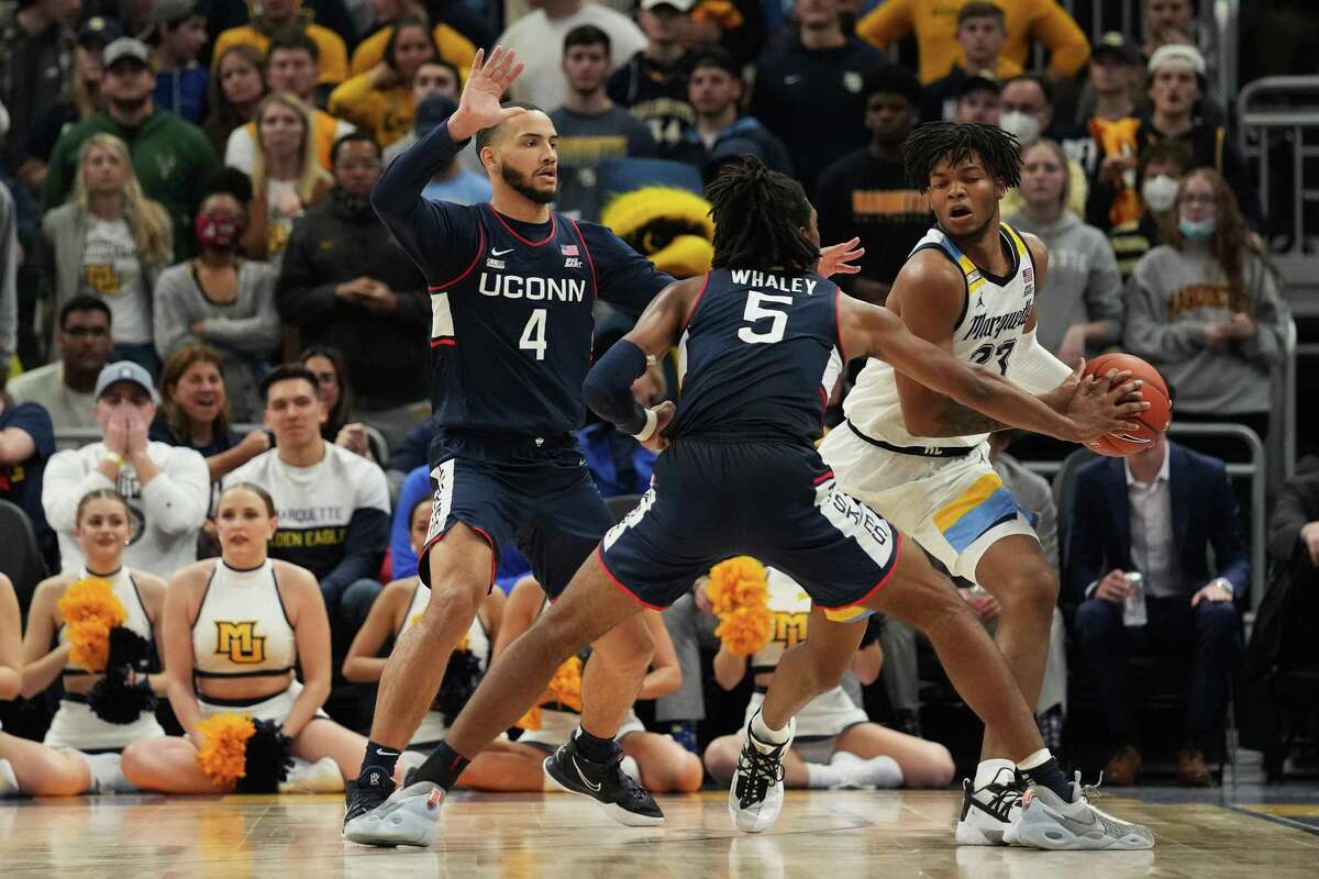 Marquette’s David Joplin (23) dribbles the ball against UConn’s Tyrese Martin (4) and Isaiah Whaley in the second half at Fiserv Forum on Tuesday in Milwaukee, Wisc. UConn won 78-70.