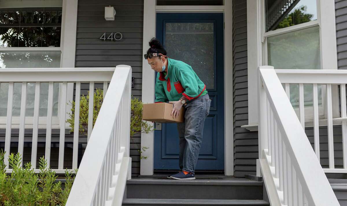 A Bentocart delivery driver leaves a box with meals at a San Francisco home.