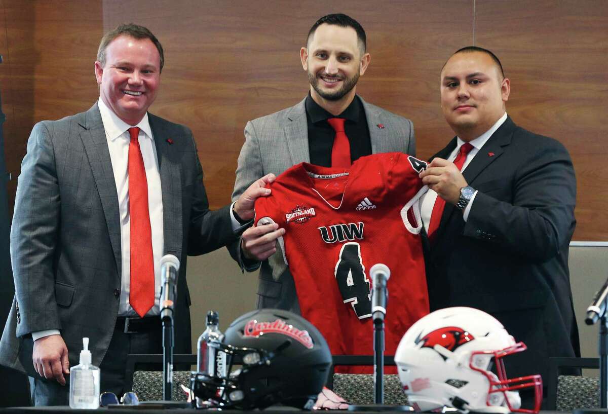 University of the Incarnate Word (UIW) will introduce new football head coach G.J. Kinne (center) during a press conference on Wednesday, Dec. 22, 2021. UIW President Thomas M. Evans (pictured left) and Athletic Director Richard Duran (right) presented their latest head football coach to the university - their fourth head coach since the inception of the school's football program. Kinne, 33, was in his first season at UCF after working as the offensive coordinator and quarterbacks coach at Hawaii in 2020. Kinne also had a stint with the San Antonio Talons and played for UTSA coach Jeff Traylor at Gilmer in 2006, then coached alongside Traylor on the staff at SMU in 2017 and Arkansas in 2018.