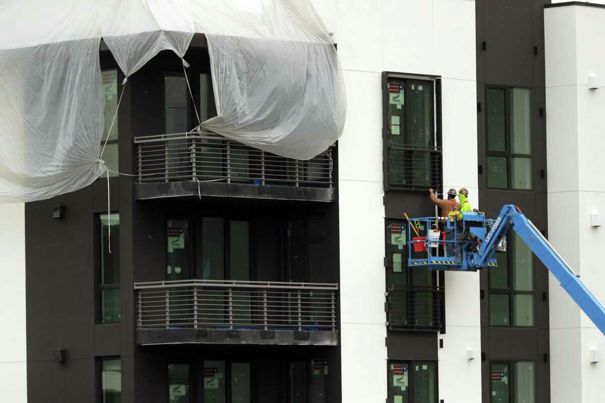 Construction workers measure near a window on the new Bristol Condominiums on Yerba Buena Island.
