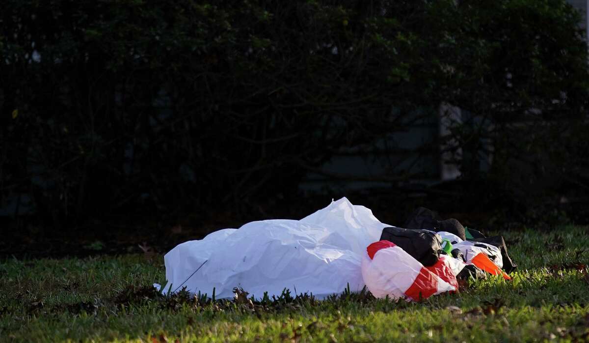 A deflated snowman decoration lays in a yard outside a Houston home on Tuesday, Dec. 21, 2021. Houston area will be experiencing a warmer than expected holiday season with temperatures hitting the 80’s on Christmas Day,
