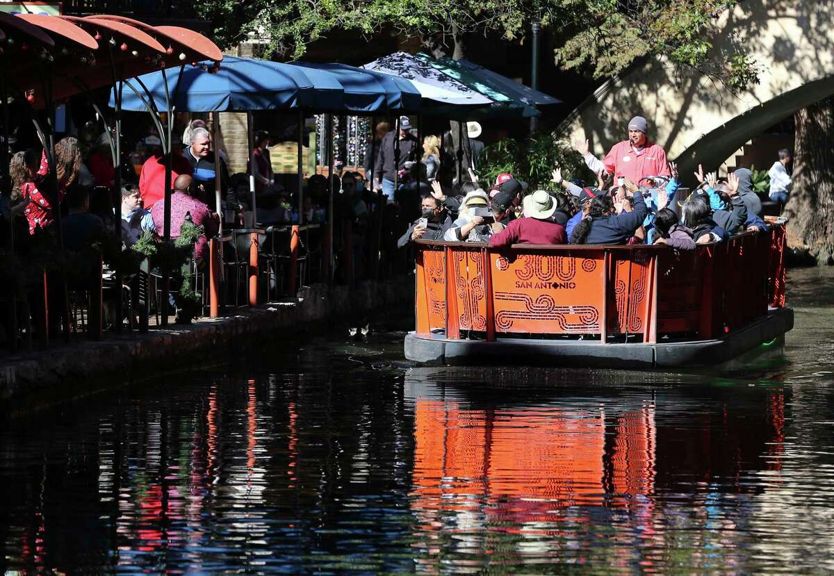 Visitors on a river cruise cruise to dine with patrons along the RiverWalk on Wednesday, December 22, 2021.