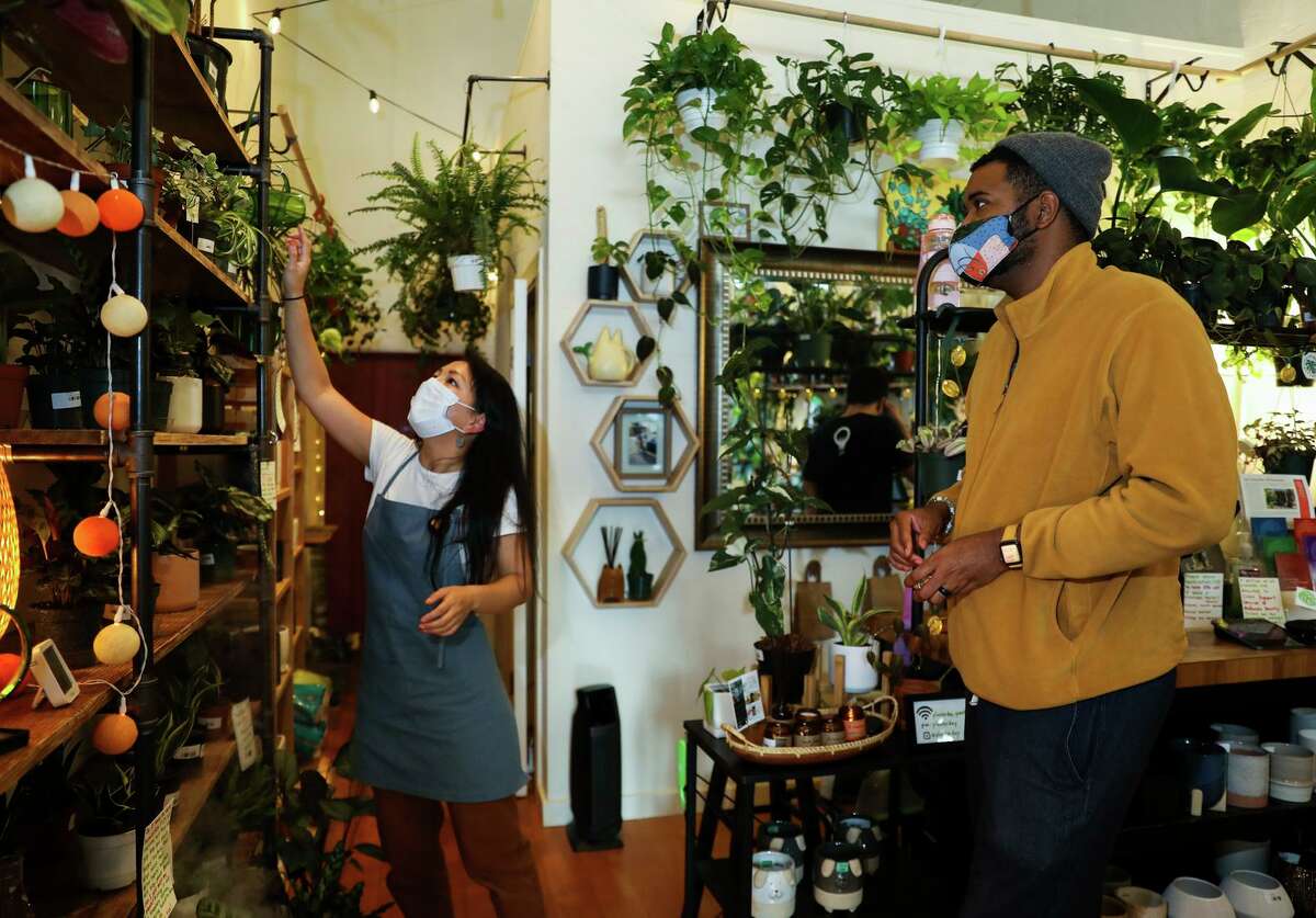 Planterday co-owner Yumi Look (left) helps customer Julius Crowe Hampton at the shop in Oakland.